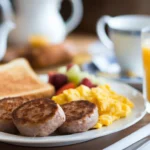 Jimmy Dean breakfast sausage patties served with scrambled eggs, toast, and fruit for a complete meal.