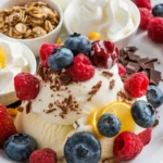 A plate showcasing creative berries and cream variations with granola, chocolate shavings, and citrus zest.